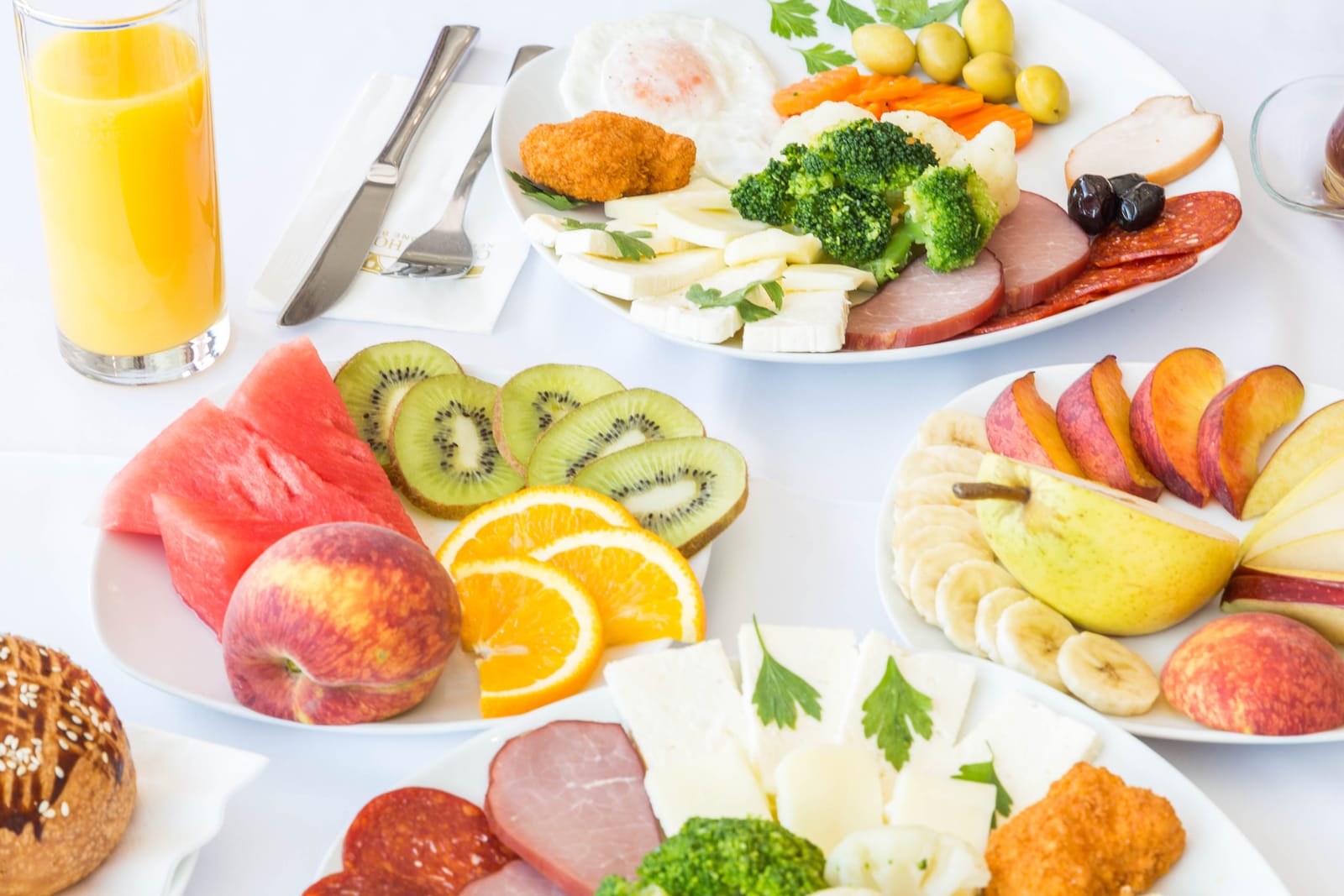 Seasonal fruit, orange juice and a savoury breakfast plate