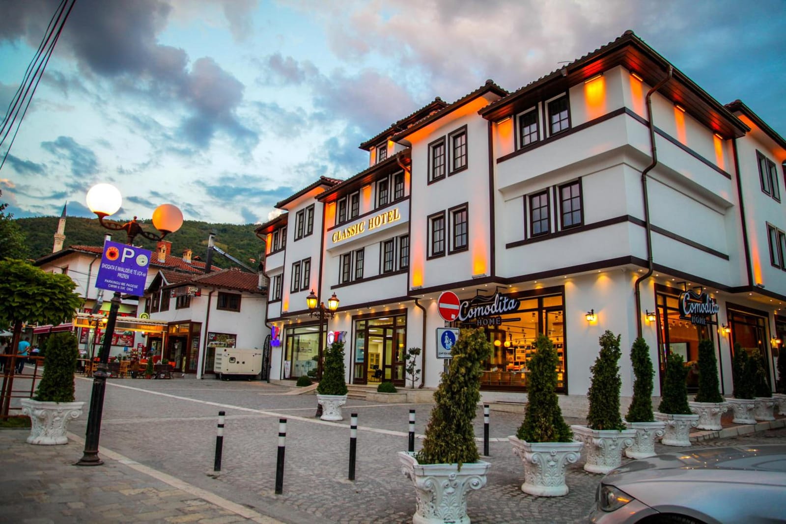 The lit façade of Classic Hotel at dusk, seen from the street