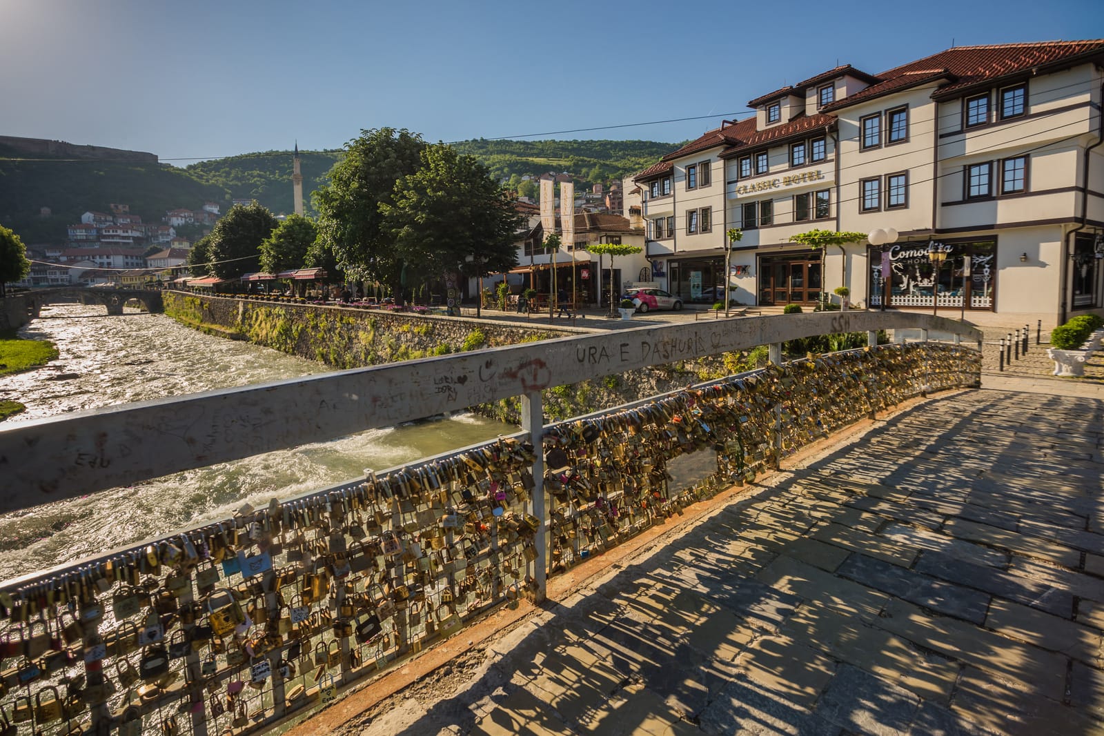 Classic Hotel on the Lumbardhi riverbank, with the Stone Bridge, Sinan Pasha minaret and Prizren Fortress upstream