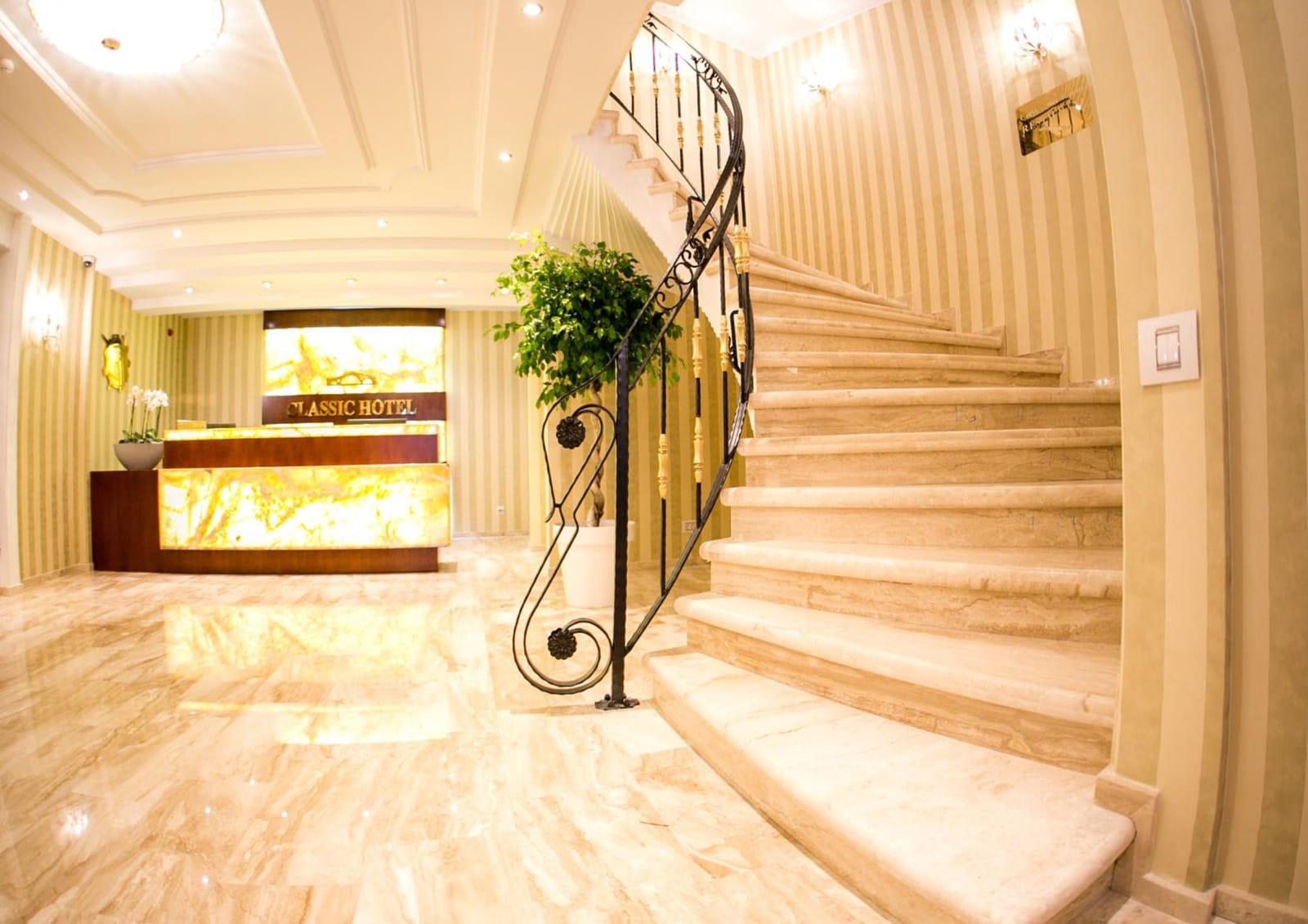The lobby with the glowing onyx reception and the spiral staircase