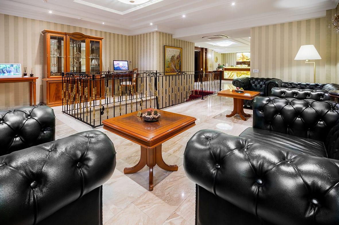 The lobby lounge with tufted leather sofas and cherry-wood tables