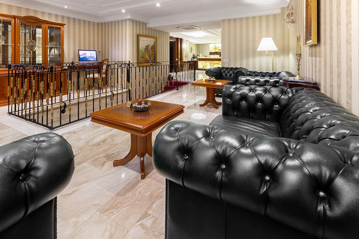 Black leather Chesterfield sofas in the lobby lounge