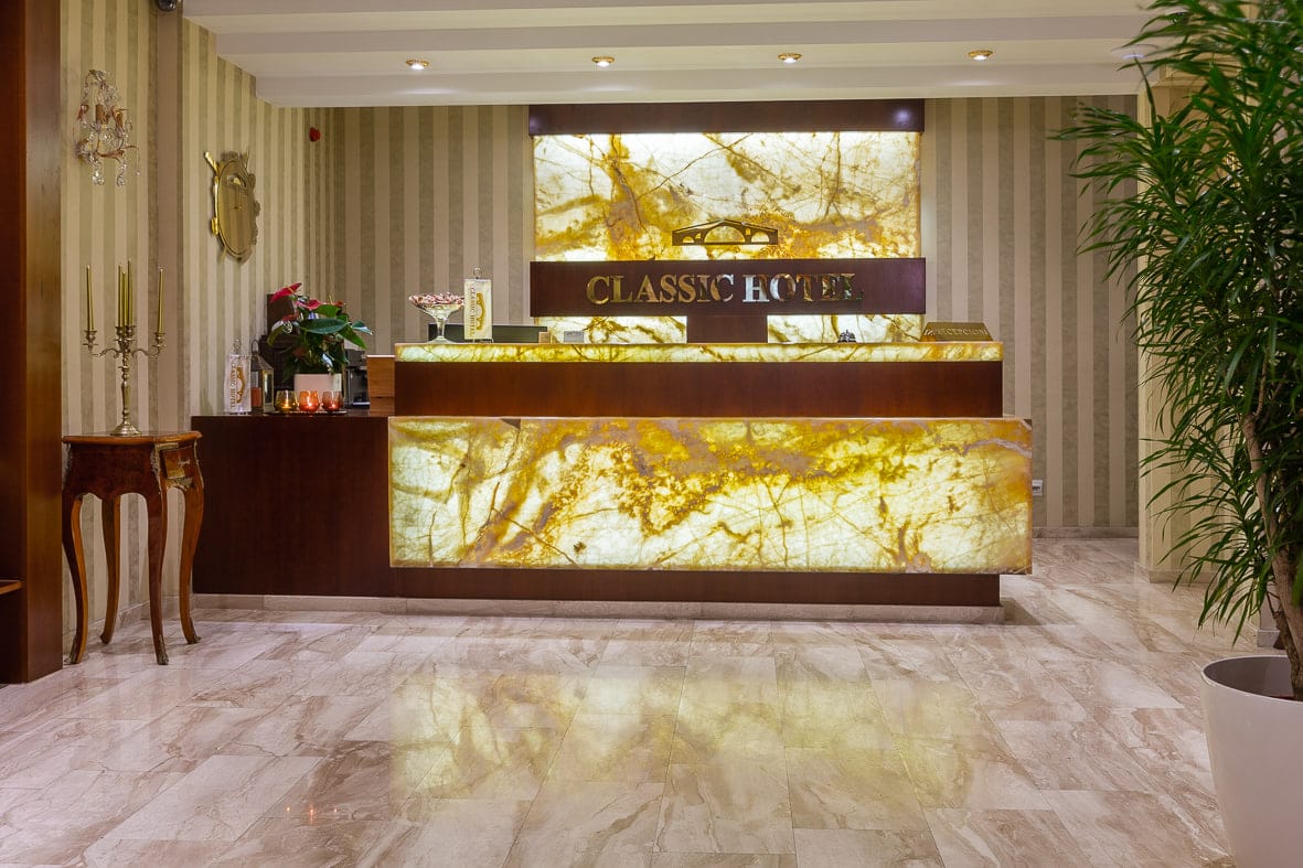 Reception framed by a palm and polished marble floors