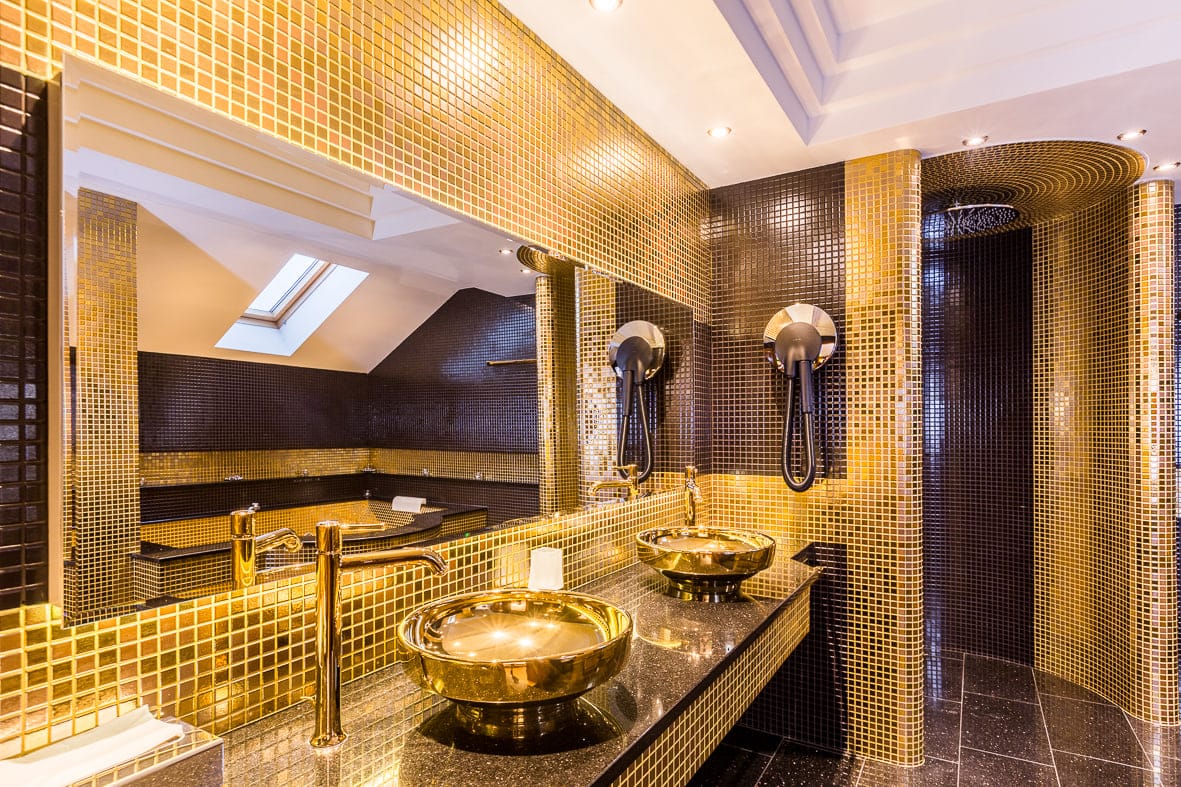 Gold mosaic suite bathroom with skylight and jacuzzi